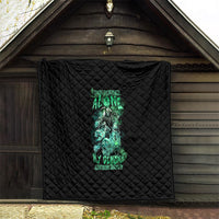 Black quilt hanging outdoors with neon teal skull reaper print centered