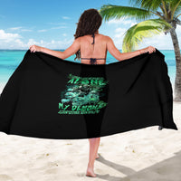 Black skull graphic sarong with green reaper design, draped over shoulders