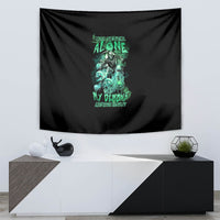 Black tapestry with teal-green skull reaper and neon slogan text, wall-hung