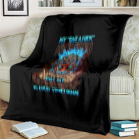 Black skull blanket with colorful tiki skull graphic and blue text, covering a couch