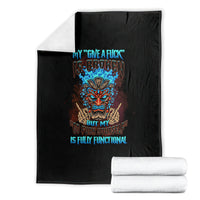 Black skull blanket with colorful tiki skull graphic and blue text, with stacked rolled sets
