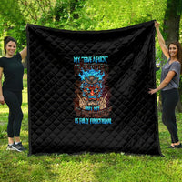 Black quilt with diamond stitching and colorful tiki skull graphic in the center