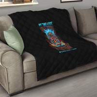 Black quilt with diamond stitching and colorful tiki skull graphic, draped over sofa