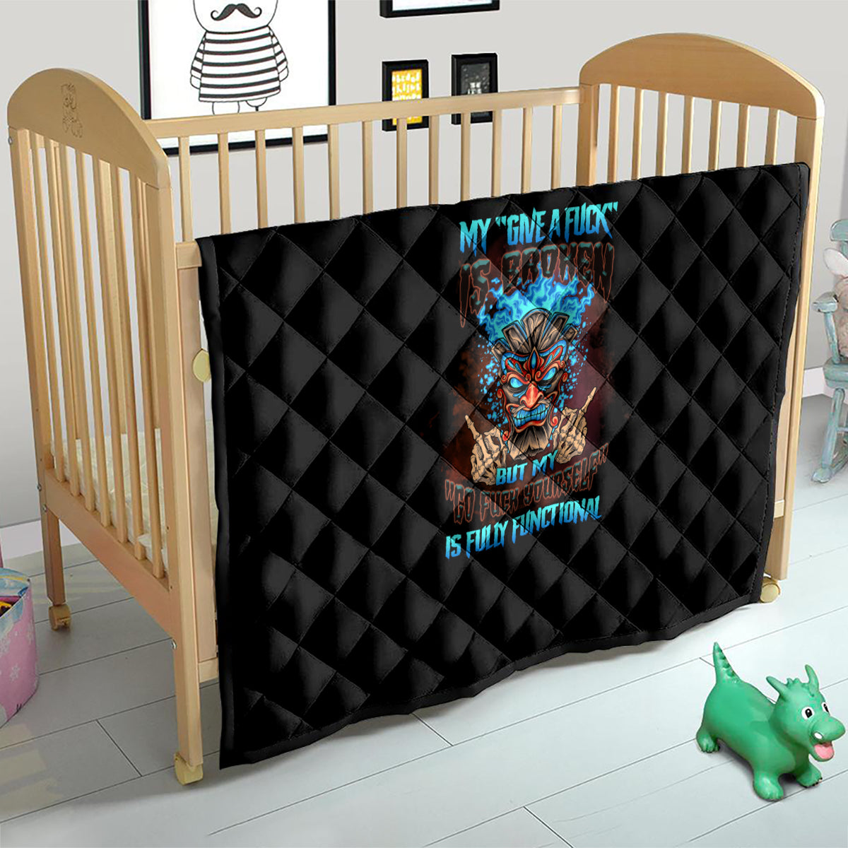 Black quilt with diamond stitching and colorful tiki skull graphic, used on a crib