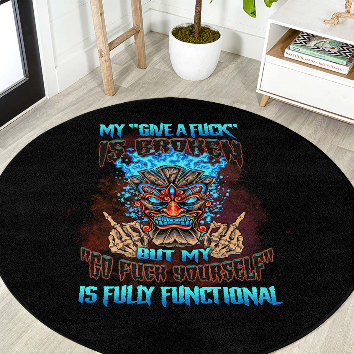 Black round carpet with centered tiki skull graphic and blue slogan text