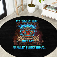 Black round carpet with centered tiki skull graphic and blue slogan text