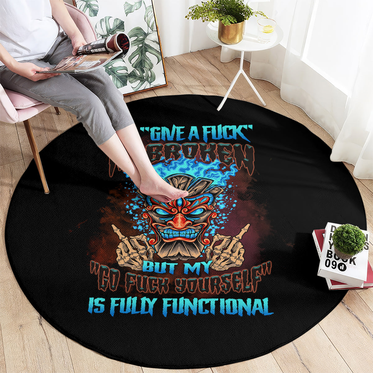 Black round carpet with colorful tiki skull graphic and slogan
