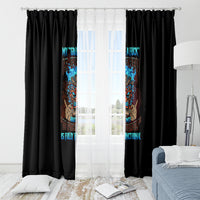 Black window curtain panels with multicolor tiki skull artwork centered over a bright window.