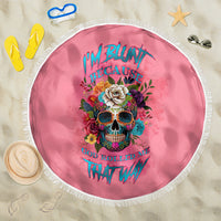 Round pink beach blanket with fringe, colorful skull floral artwork centered