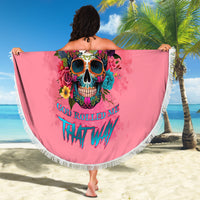 Round pink beach blanket with fringe border, colorful skull floral design and text