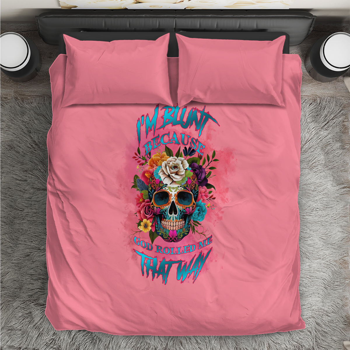 Pink bedding set with duvet and two pillows, featuring colorful skull and rose graphic