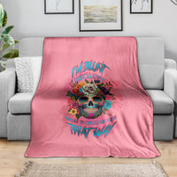 Pink fleece blanket with colorful skull graphic and bold text, draped on a sofa