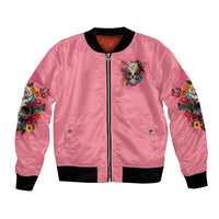 Pink bomber jacket with front zip, black ribbed trim, colorful floral skull chest graphic