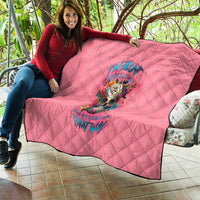 Pink quilt blanket with diamond stitching and colorful skull floral print