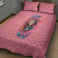 Pink quilt bed set with two matching pillows, black trim and colorful skull-floral graphic