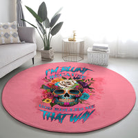 Pink round carpet with colorful skull and floral accents, stylized lettering design