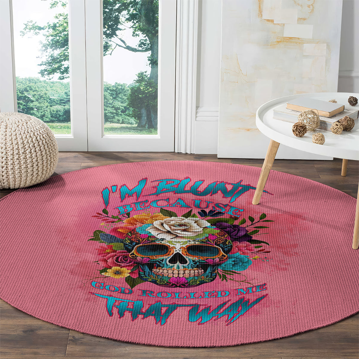 Pink round carpet with vivid skull artwork and decorative stylized lettering, rug