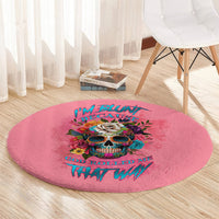 Pink round carpet rug with bright skull graphic and stylized lettering, decorative floor mat