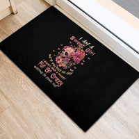 Black rubber doormat with pink skull-and-flowers graphic and colorful quote design