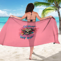 Pink sarong with colorful skull graphic and bold text, draped on model