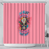 Pink shower curtain with colorful skull, roses, and drip-style text graphic in center