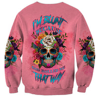 Pink crewneck sweatshirt, back view, with floral skull and colorful lettering; long sleeves