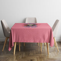 Pink tablecloth with multicolor floral quote print on a square dining table.