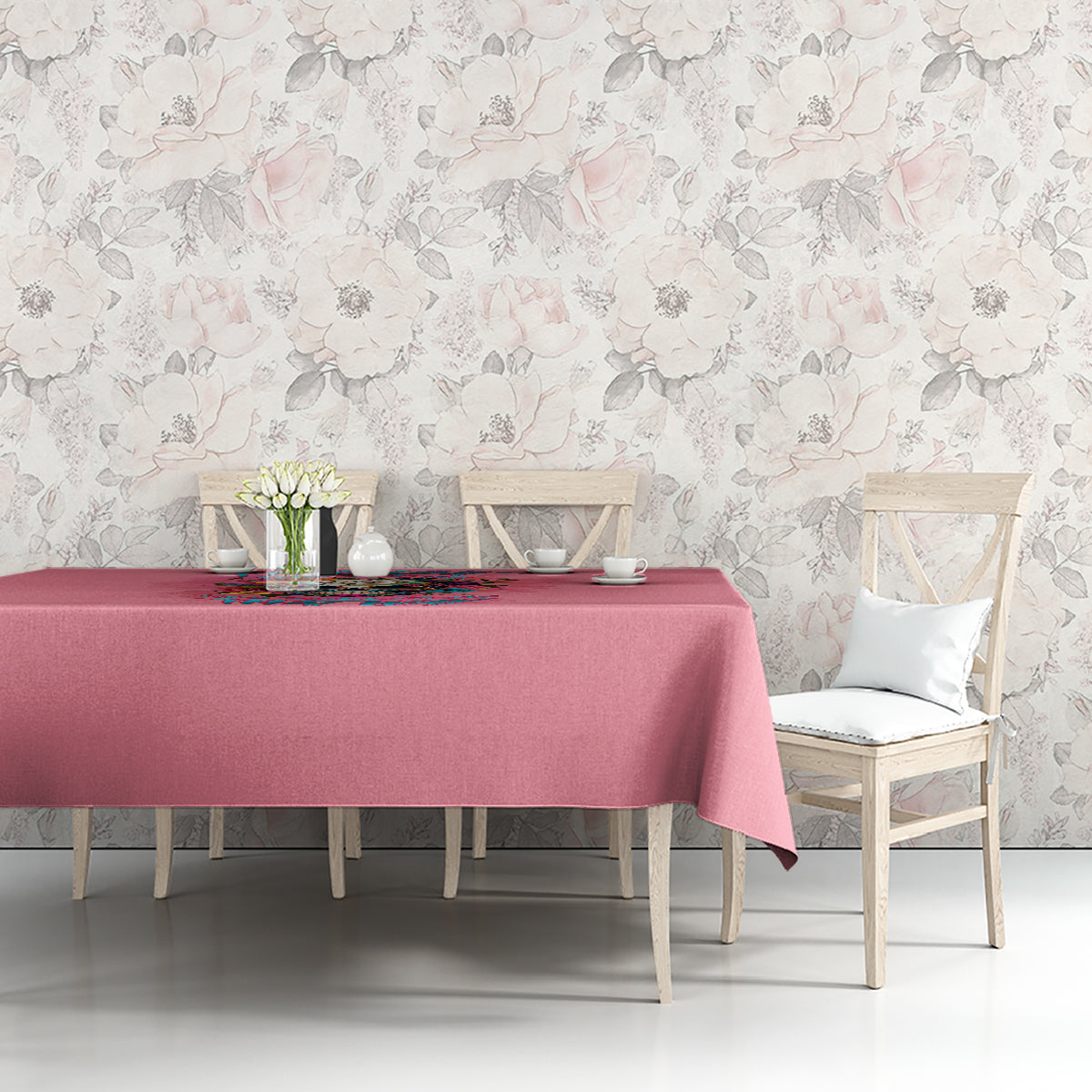 Pink tablecloth with multicolor floral quote design, styled on a dining table.
