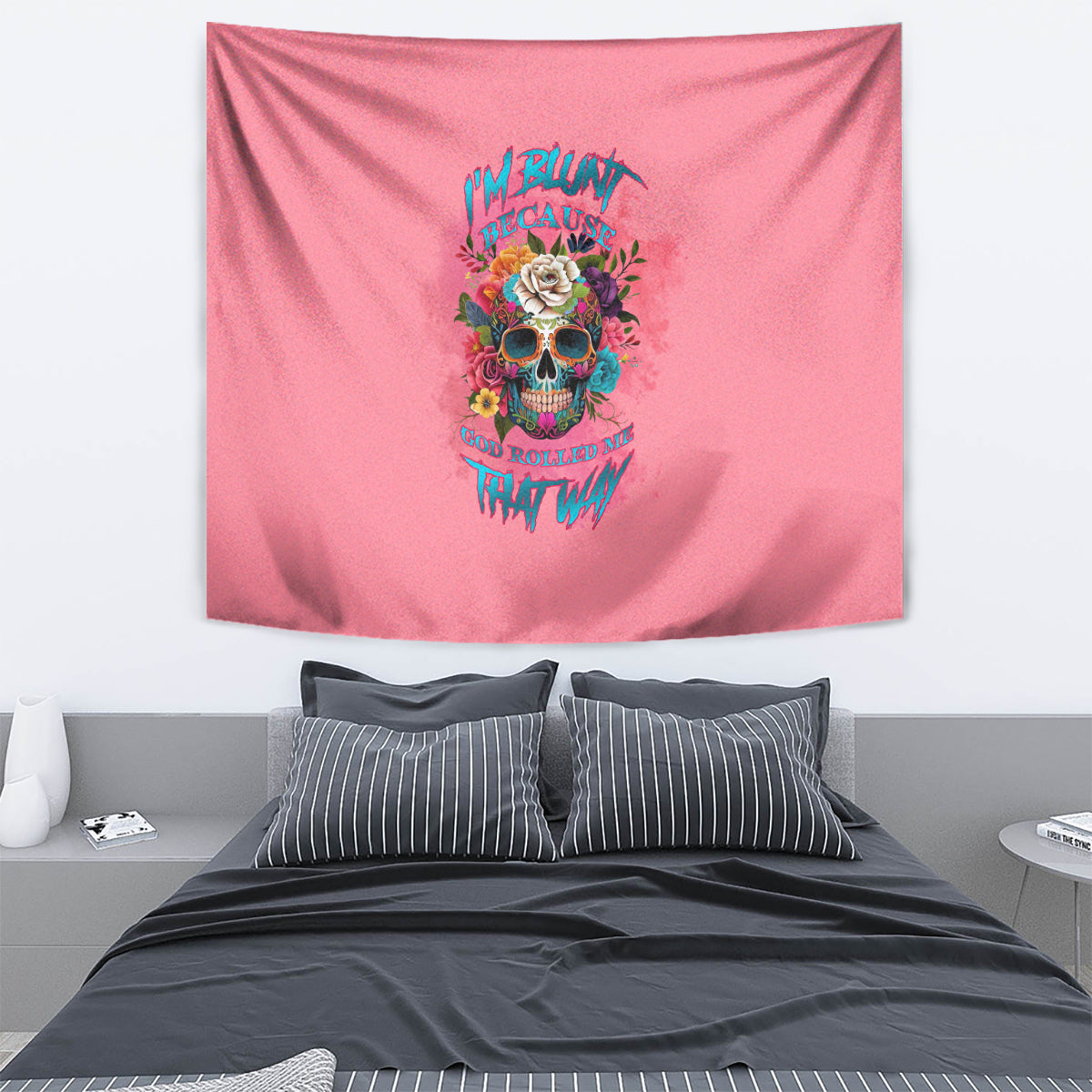 Pink tapestry with centered skull, rose flowers, and colorful text graphic