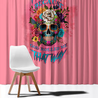 Pink window curtain with colorful skull and floral graphic, hanging in front of chair