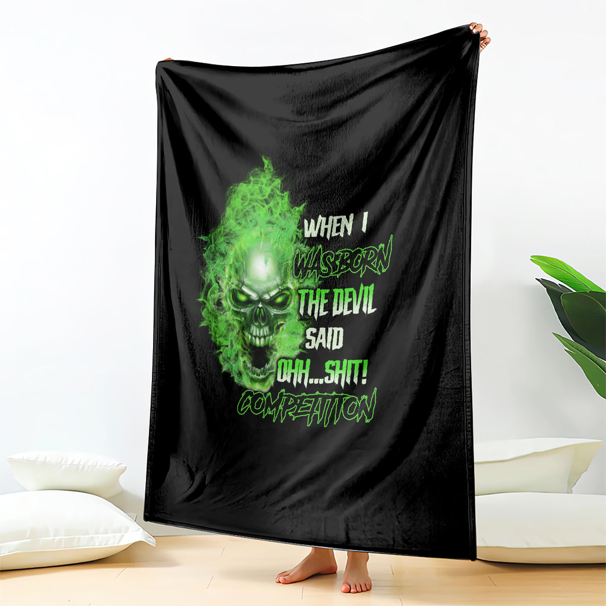 Black skull graphic blanket draped over a standing person