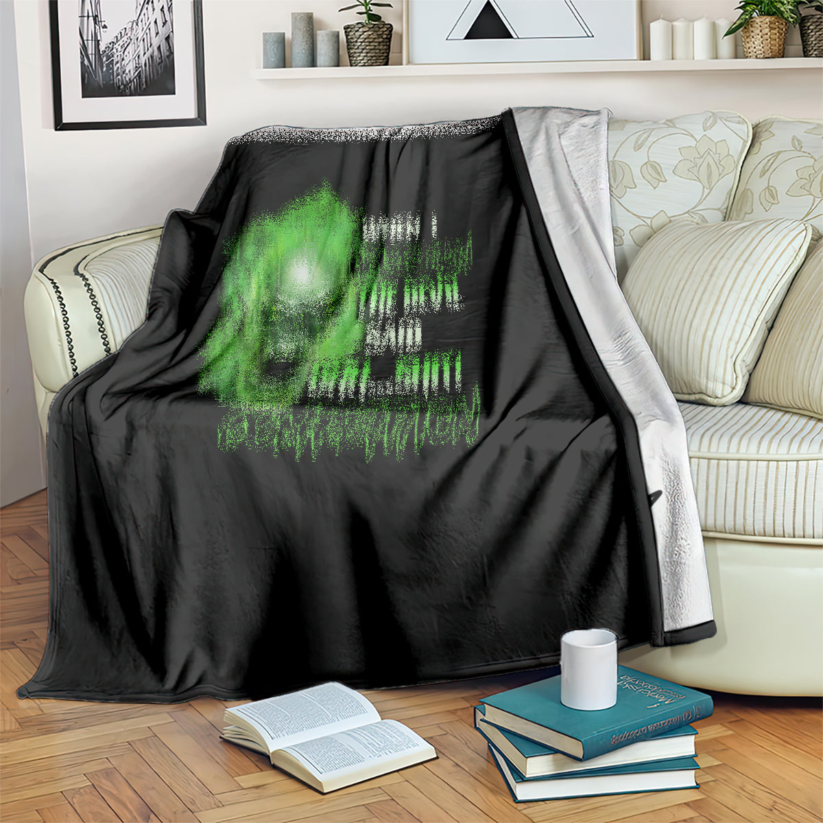 Black throw blanket with green neon skull design on living room sofa