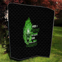 Black quilt blanket with green skull artwork and stacked neon text, diamond stitch border