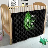 Black quilt blanket with green skull graphic and neon-style text, quilted diamond pattern