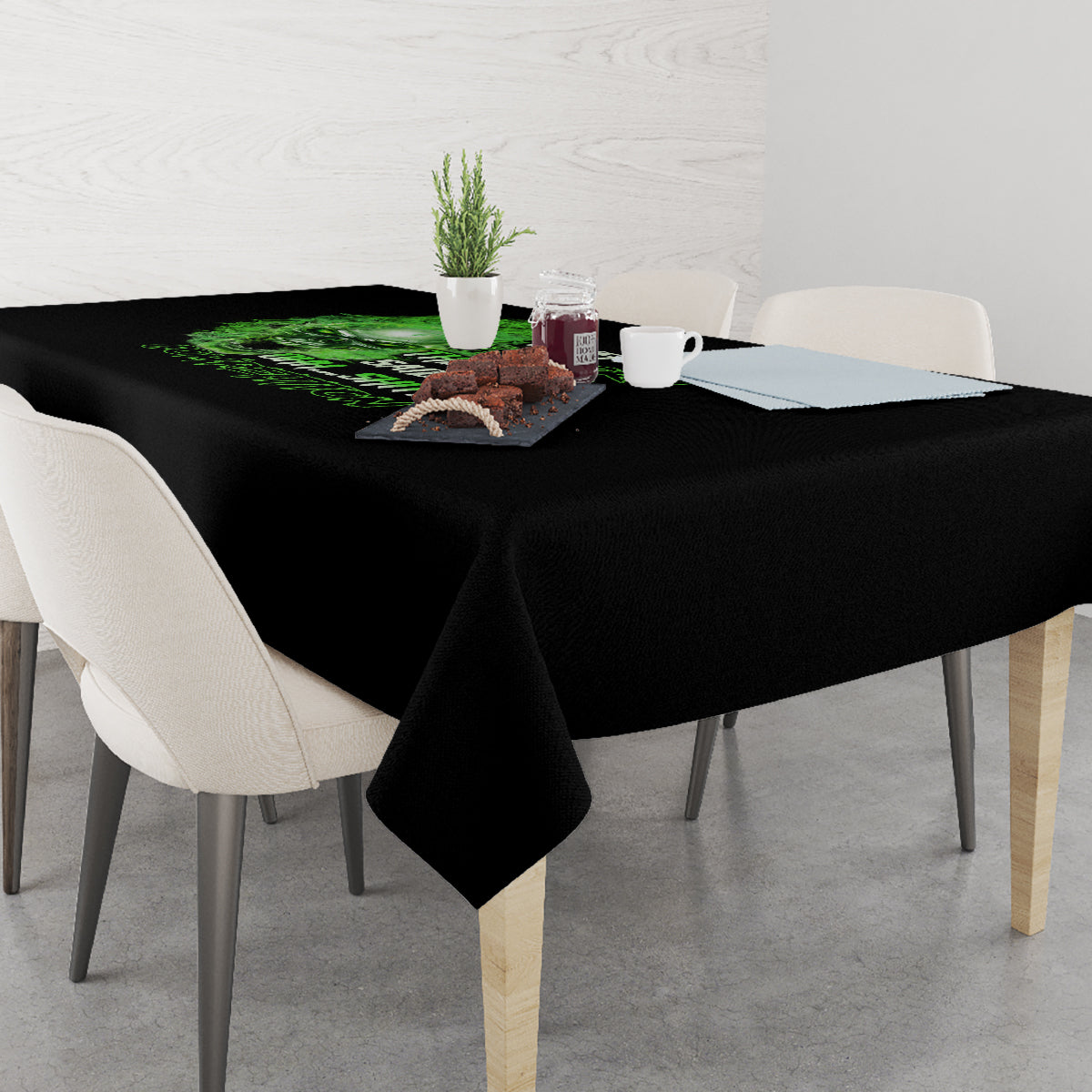 Black tablecloth on dining table with neon green skull and dark graphic text