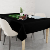 Black tablecloth on dining table with neon green skull and dark graphic text