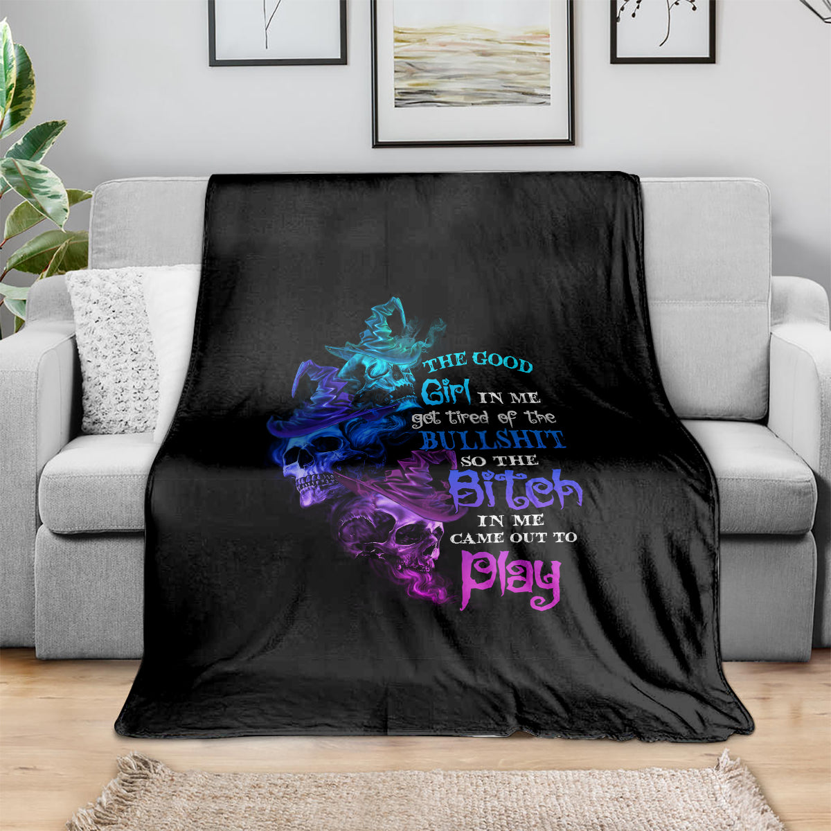 Black Halloween blanket with neon skull-witch graphic and purple/blue text