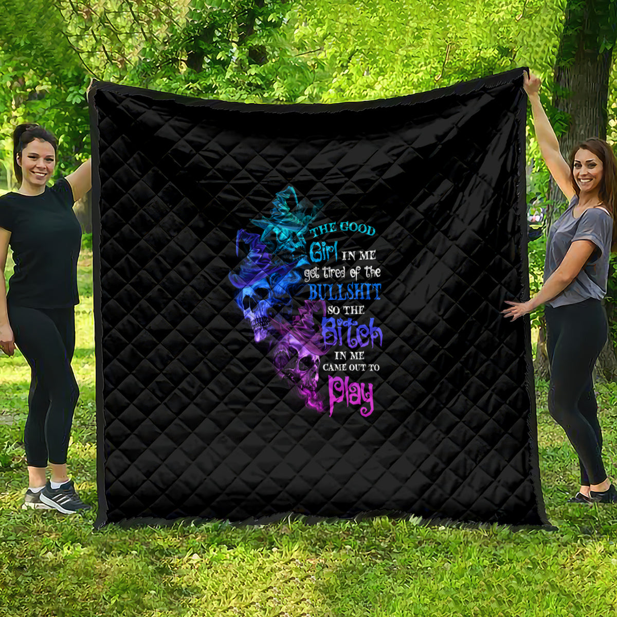 Black quilt with colorful skull-witch graphic and bold neon text on front