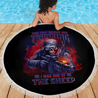 Round beach blanket, black with skull-gun design and white fringed border