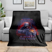 Black graphic fleece blanket with armored skull holding rifle and red-blue text