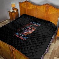 Black quilt blanket with diamond stitching and skull graphic on bed