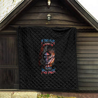 Black quilt blanket with diamond quilting and skull graphic hanging on porch