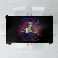 Black tablecloth with centered colorful graphic design and folded corners