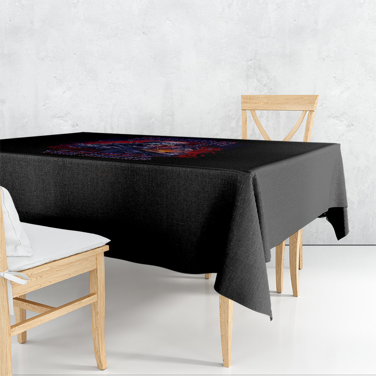 Black square tablecloth with colorful graphic print, draped over dining table