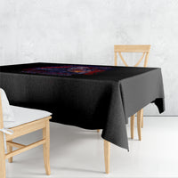 Black square tablecloth with colorful graphic print, draped over dining table