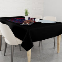 Black tablecloth with colorful graphic strip along the edge on dining table