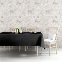 Black tablecloth with colorful graphic strip on dining table beside chairs