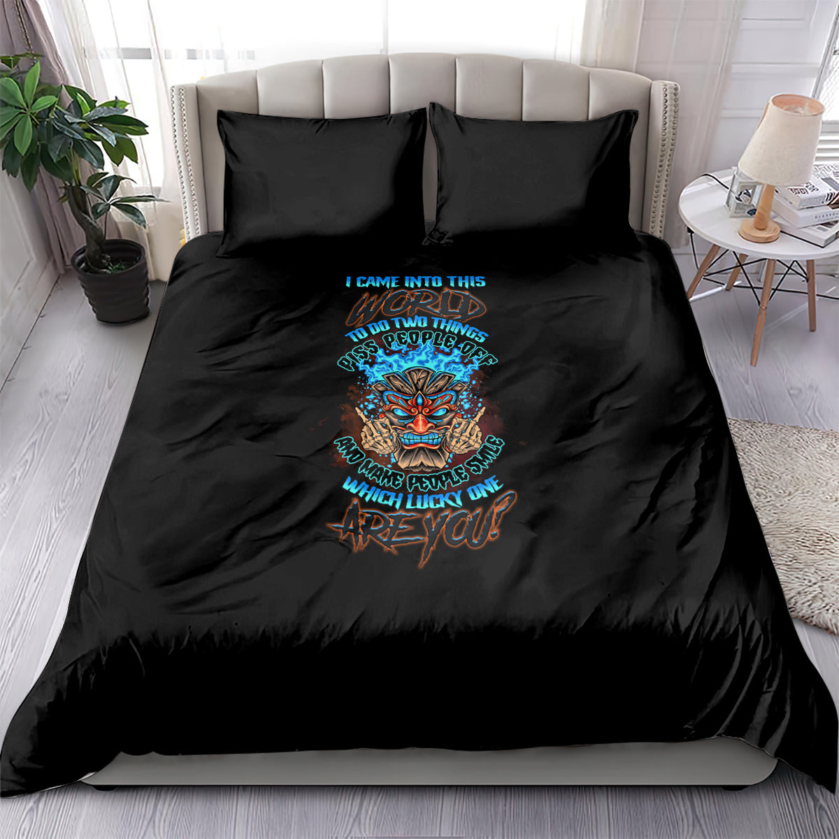 Black bedding set with colorful skull tiki graphic and teal lettering on comforter