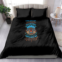 Black bedding set with colorful skull tiki graphic and teal lettering on comforter