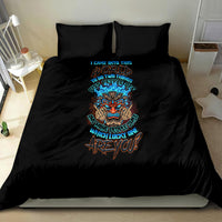 Black bedding set with colorful skull tiki graphic on comforter, front full-bed view